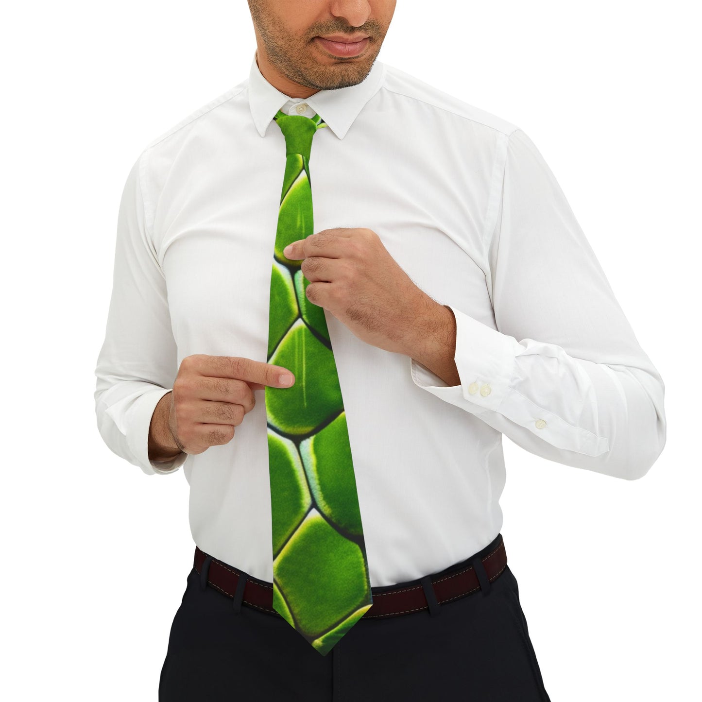 A man in a white shirt and black pants is adjusting his green tie with his fingers.