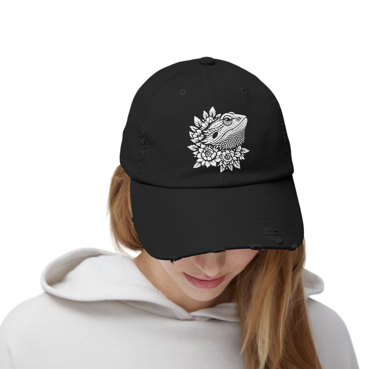 A person wearing a black baseball cap with a white floral design on the front.