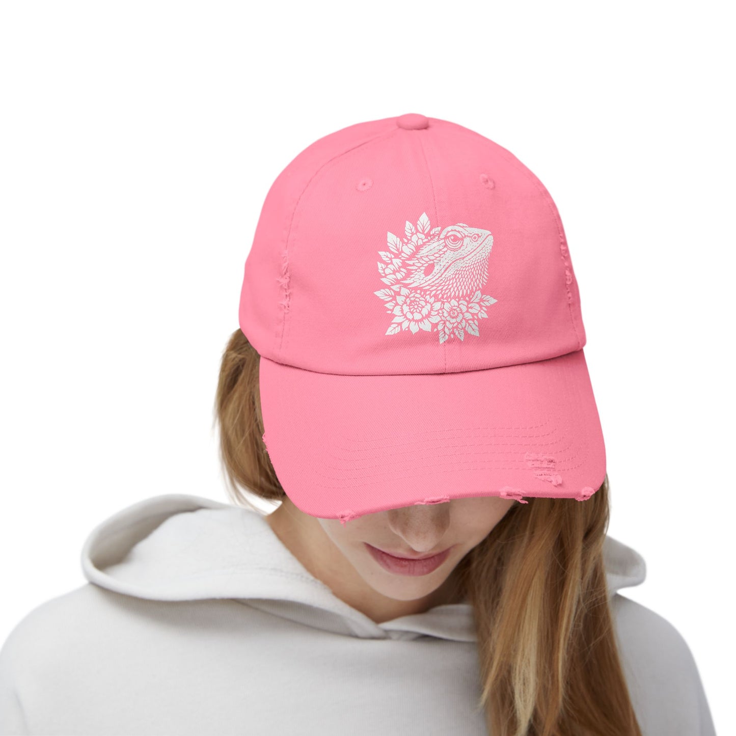 A person wearing a pink baseball cap with a white design on the front.