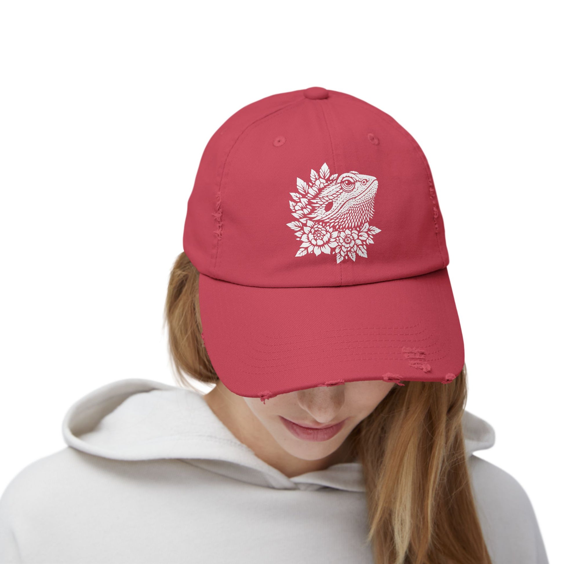A person wearing a red baseball cap with a white design on the front.