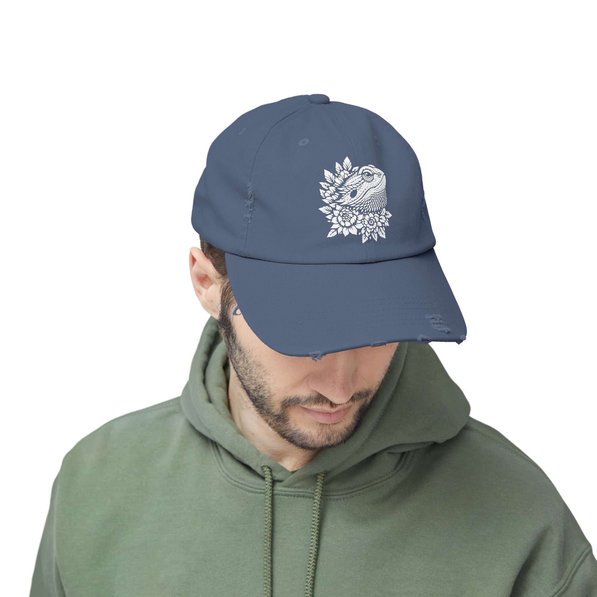 A man wearing a navy blue baseball cap with a white floral design on it.