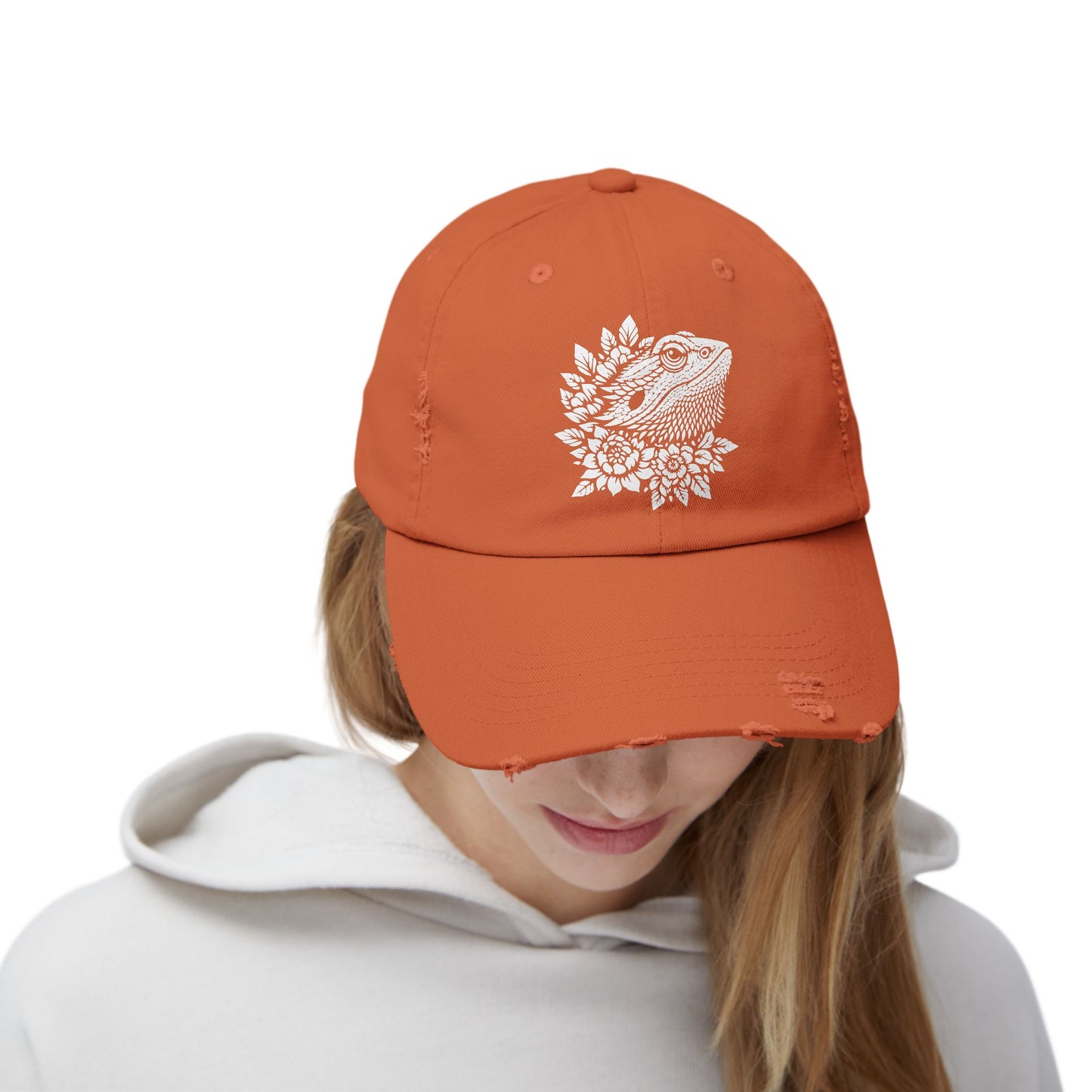 A person wearing an orange baseball cap with a white design on the front.